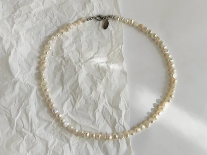 Collana di perle di fiume bianche, con chiusura a moschettone.